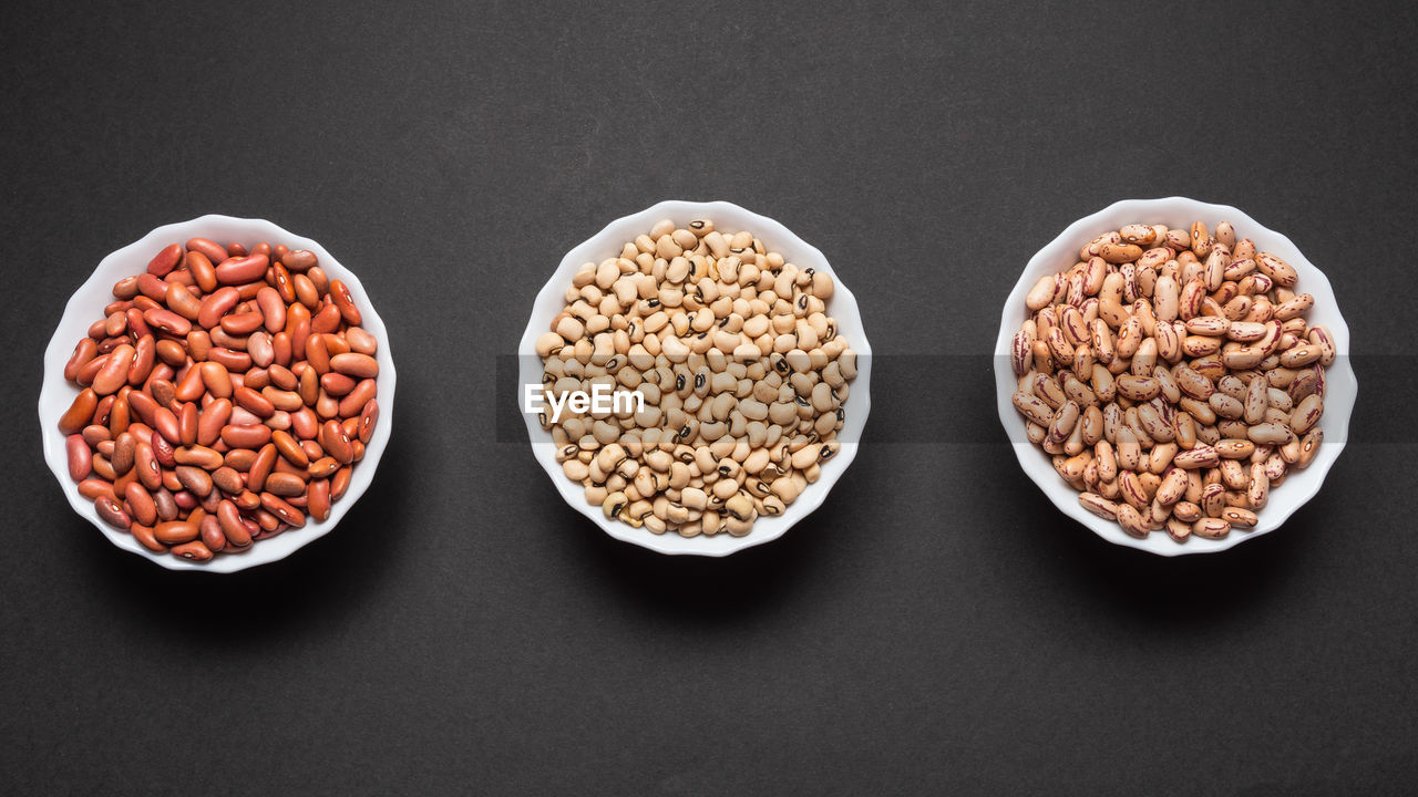 Close up of coffee beans with coffee powder as background