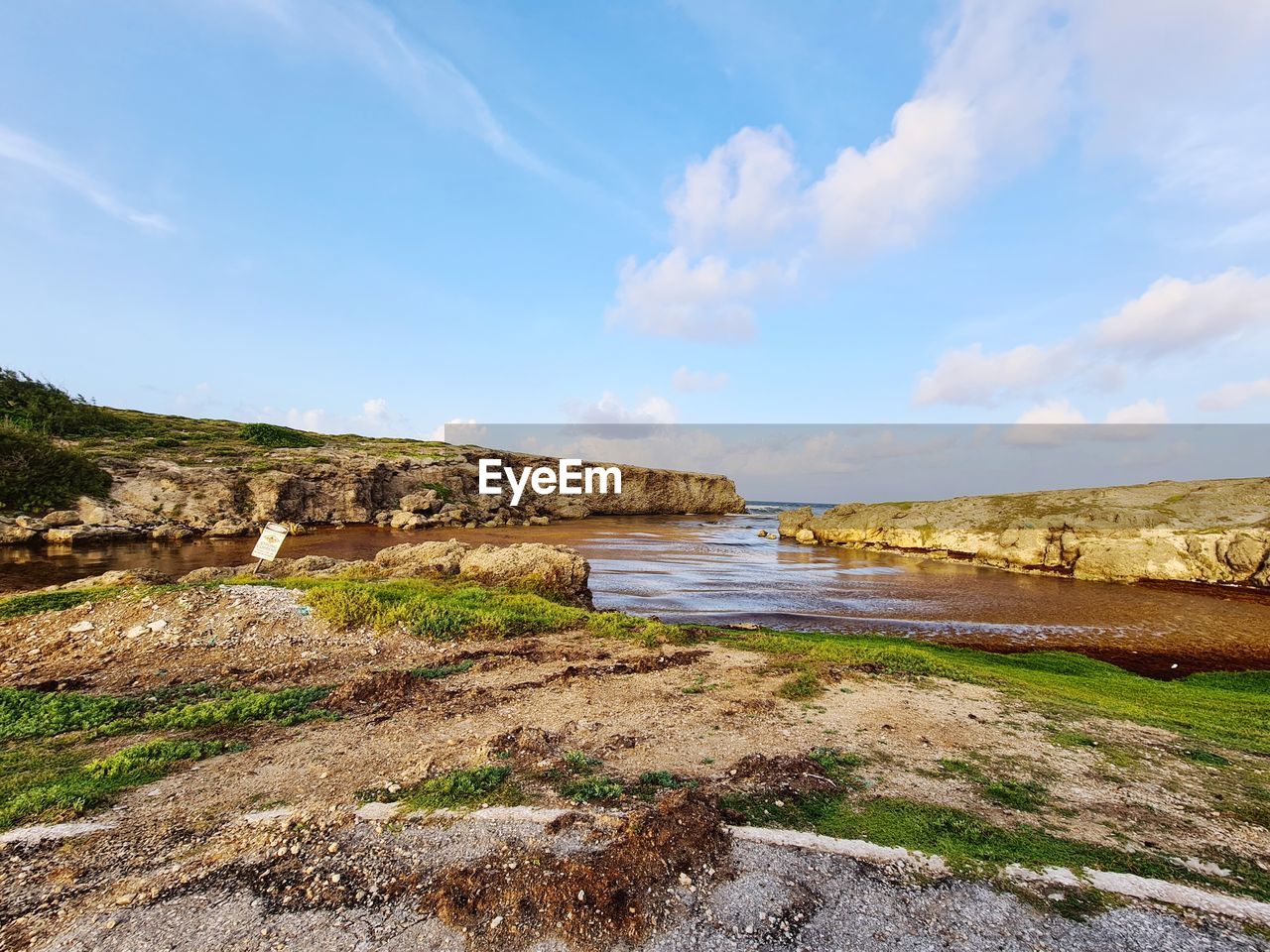 SCENIC VIEW OF SEA SHORE AGAINST SKY