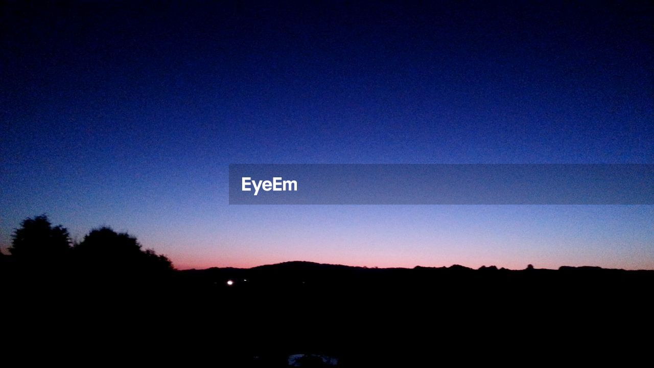 SILHOUETTE OF TREES AGAINST SKY