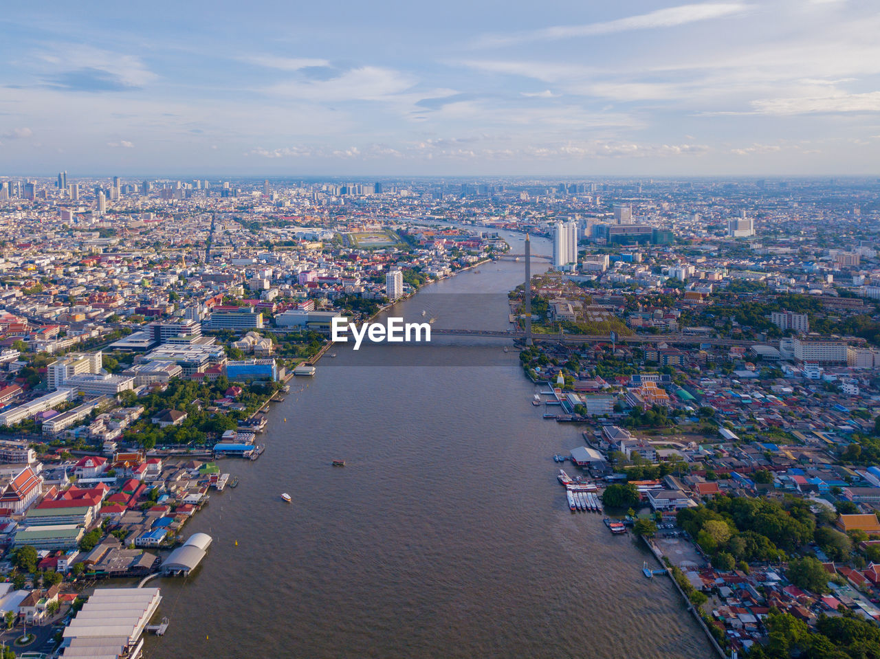 High angle view of buildings by canal against sky