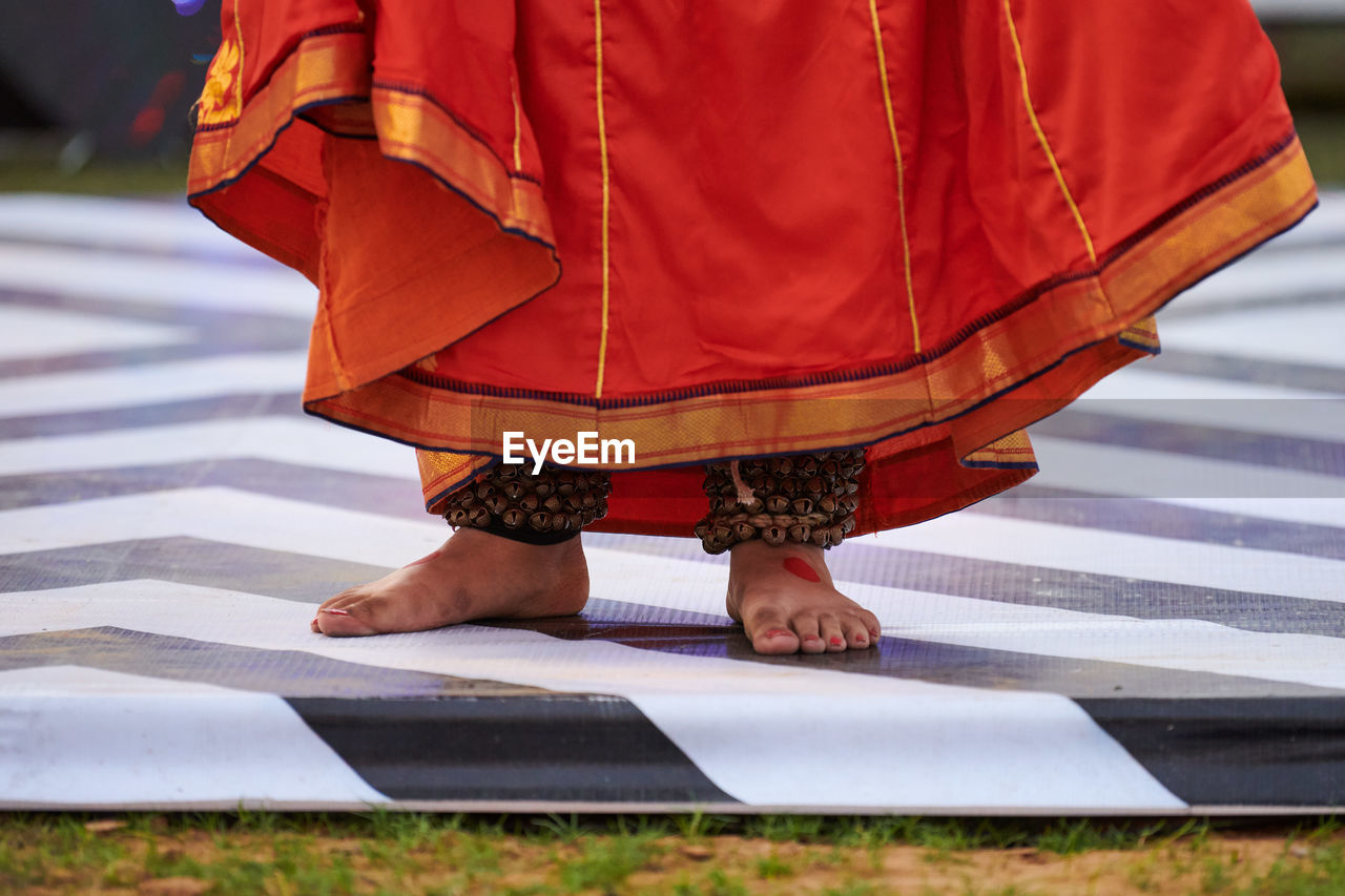 low section of woman standing in traditional clothing