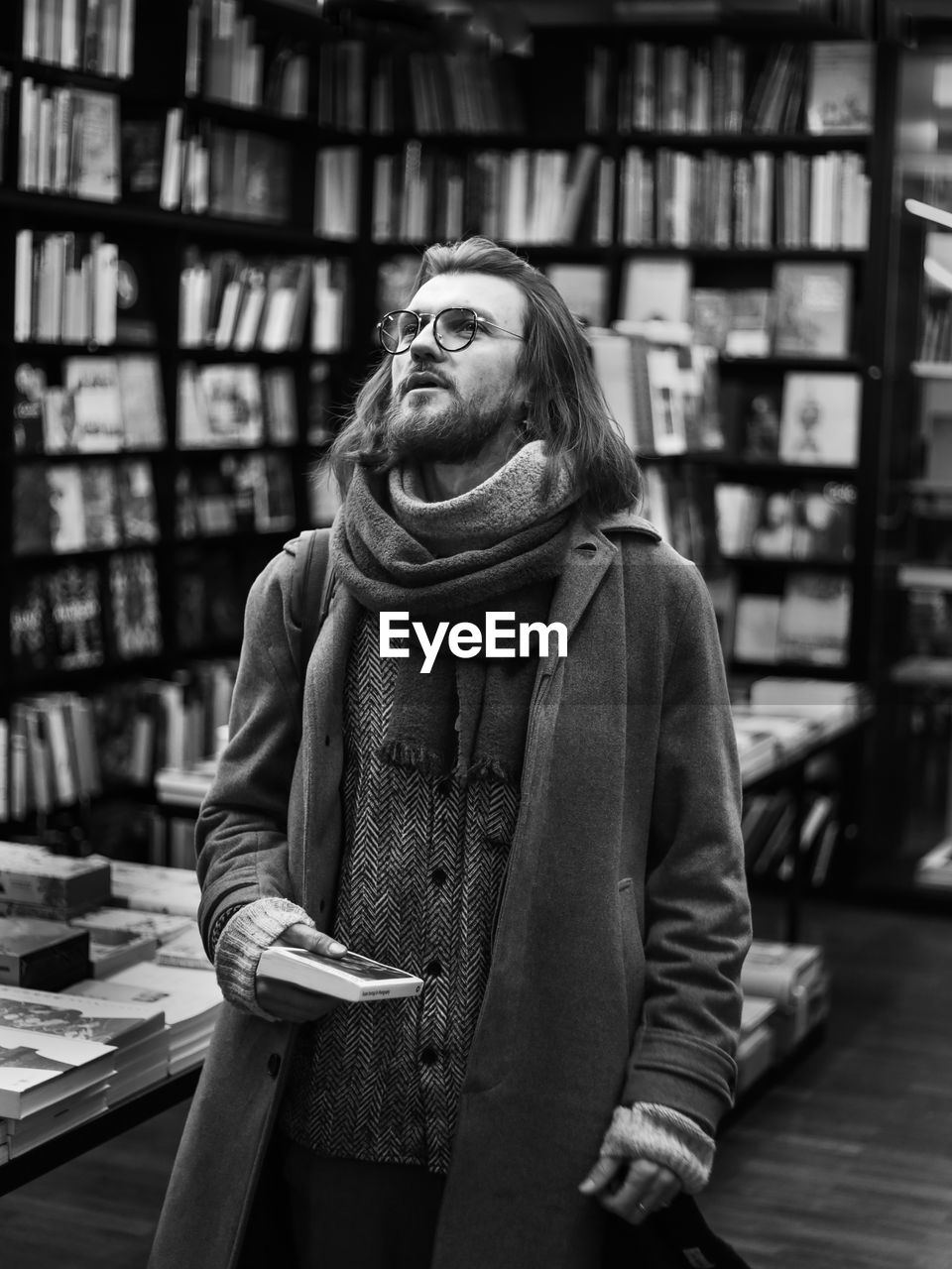 Portrait of young mann standing in library