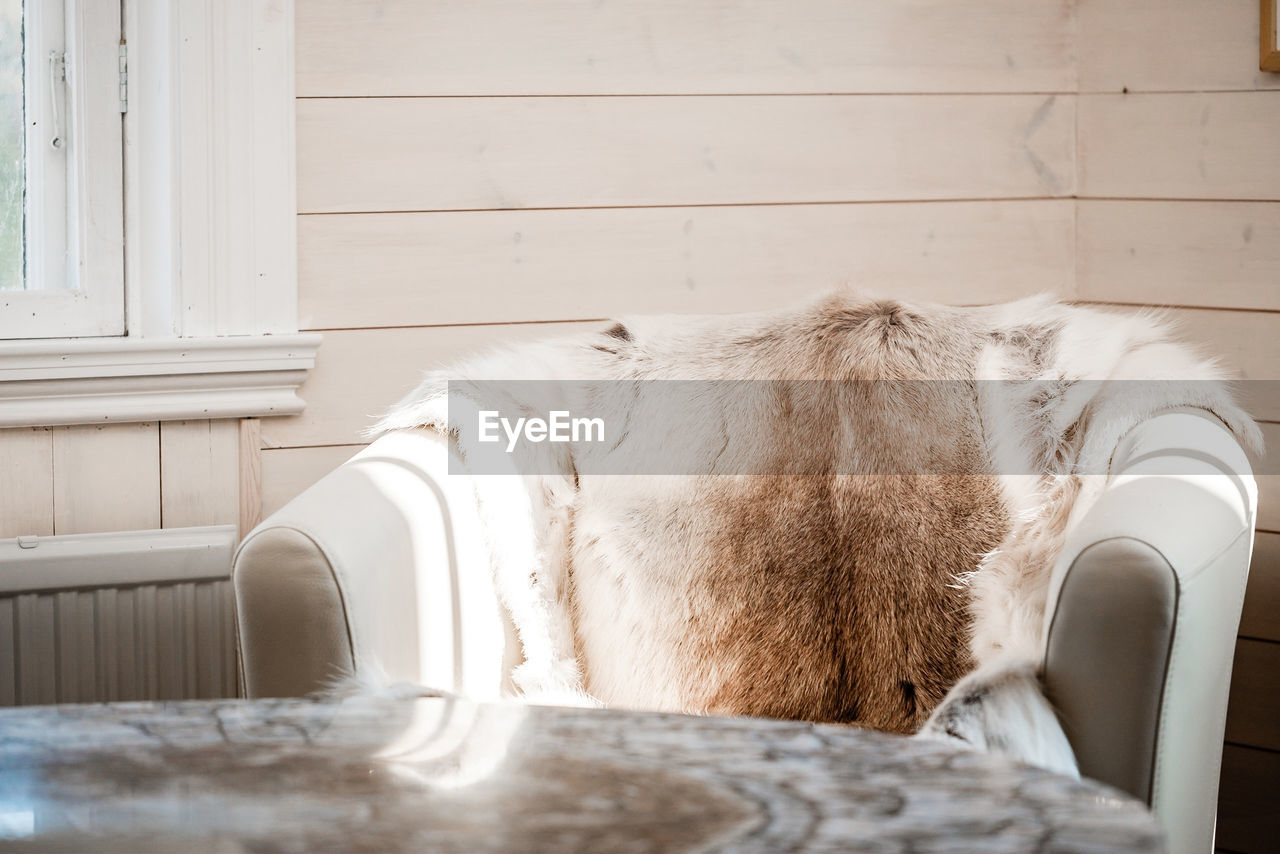 Close-up of armchair with fur on it 