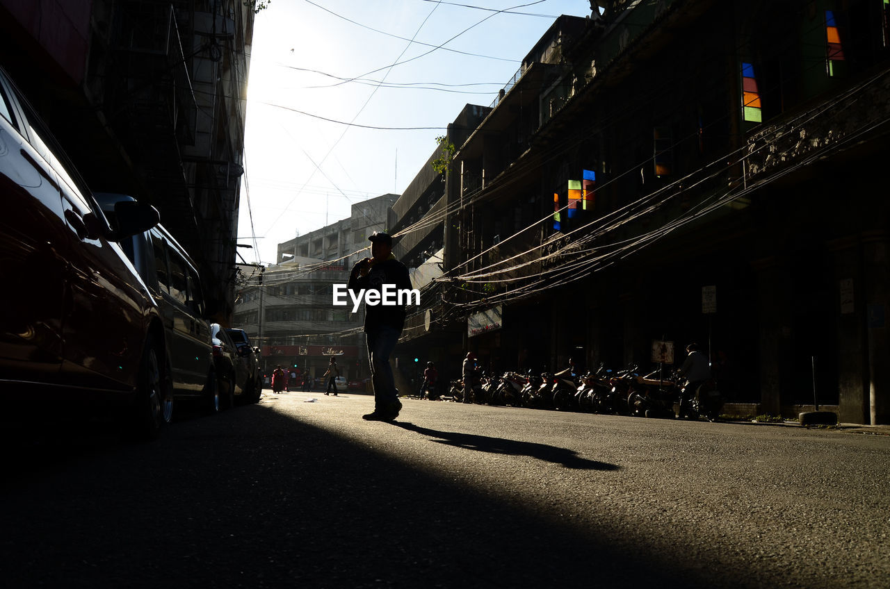 PEOPLE WALKING ON STREET IN CITY