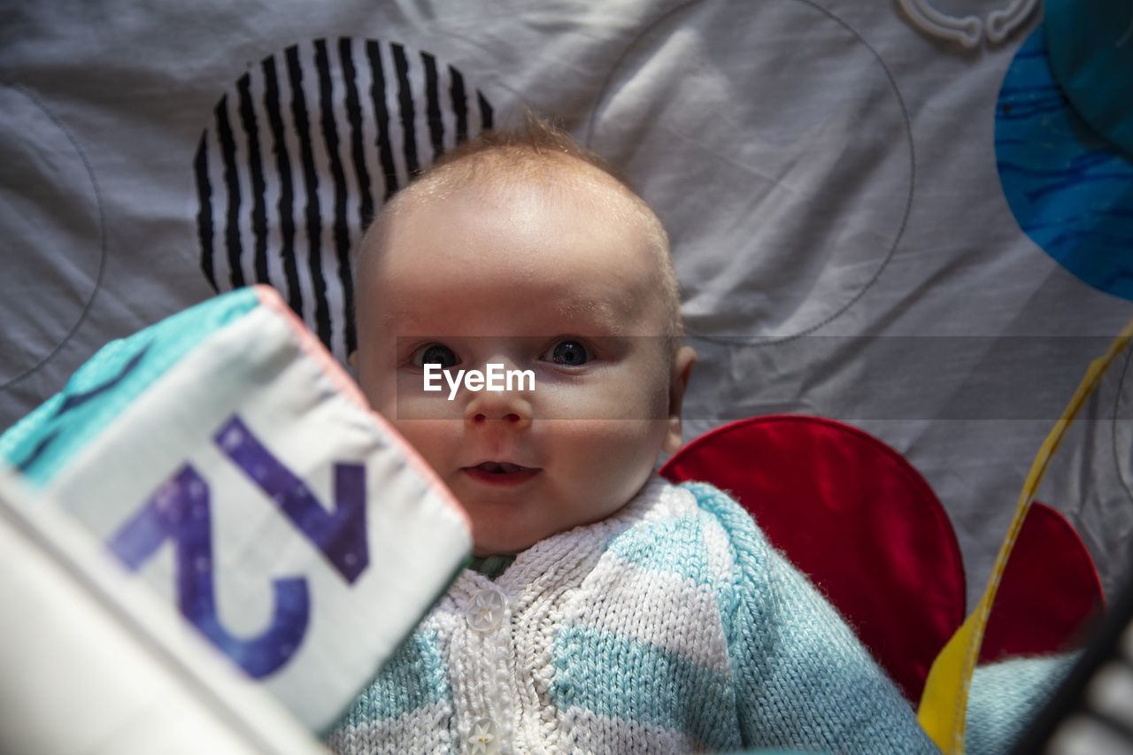 high angle view of cute baby girl with stuffed toy