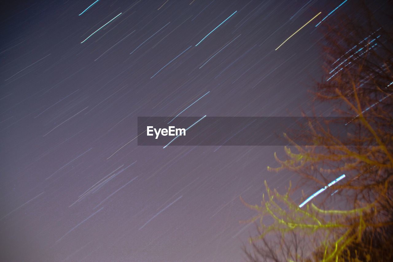 Low angle view of star trails