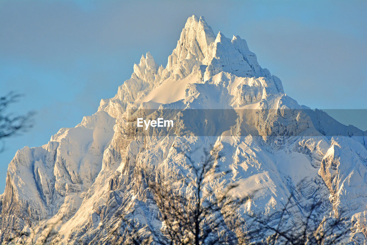 Scenic view of snowcapped mountains against clear sky