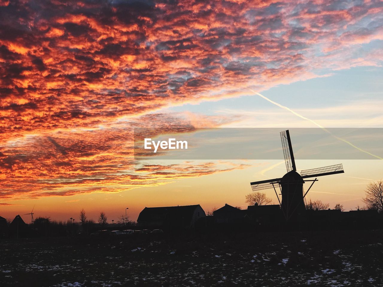 SILHOUETTE WINDMILL ON FIELD AGAINST SKY AT SUNSET