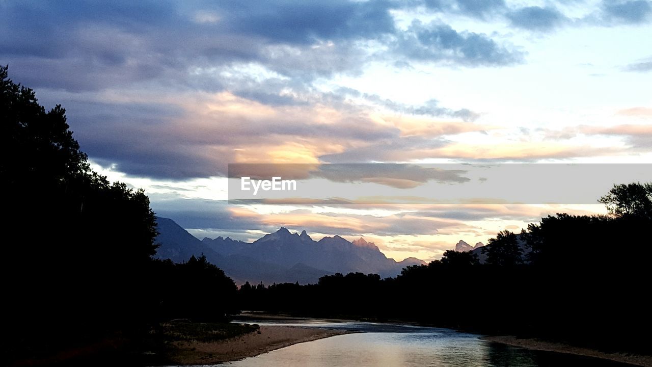 VIEW OF RIVER AGAINST CLOUDY SKY