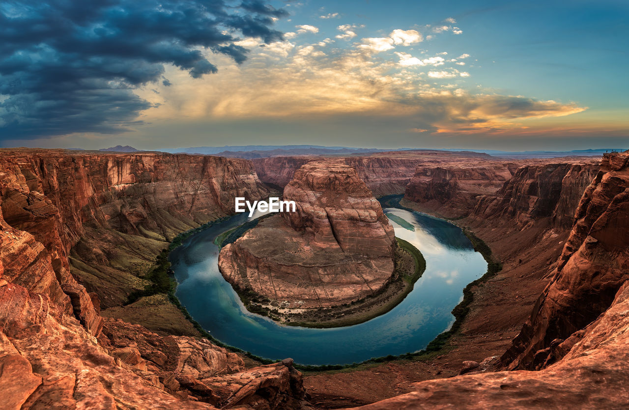 High angle view of horseshoe bend against sky during sunset