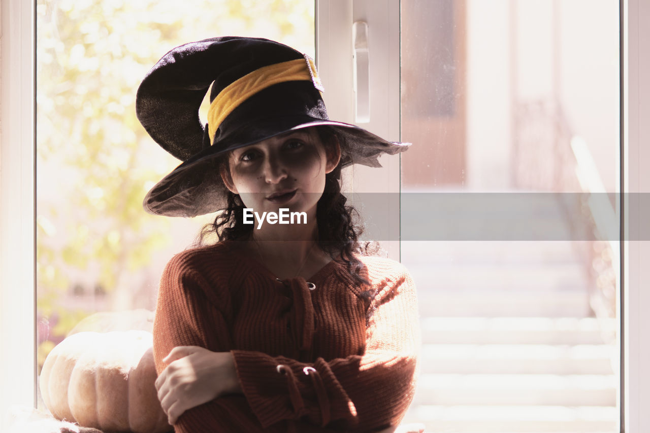 Portrait of young woman in hat