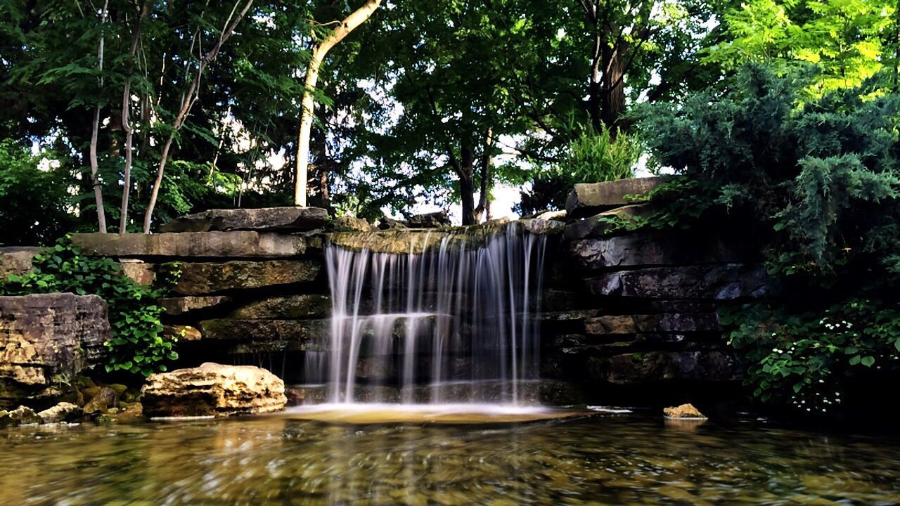 View of waterfall with stream in foreground