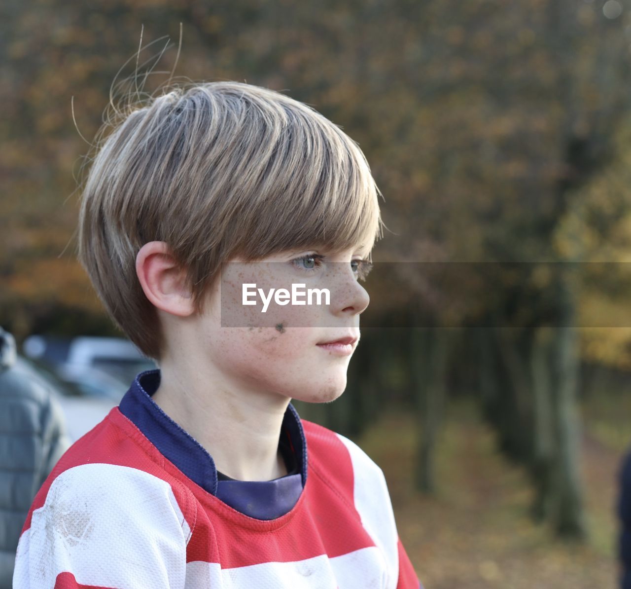 Close-up of boy looking away outdoors