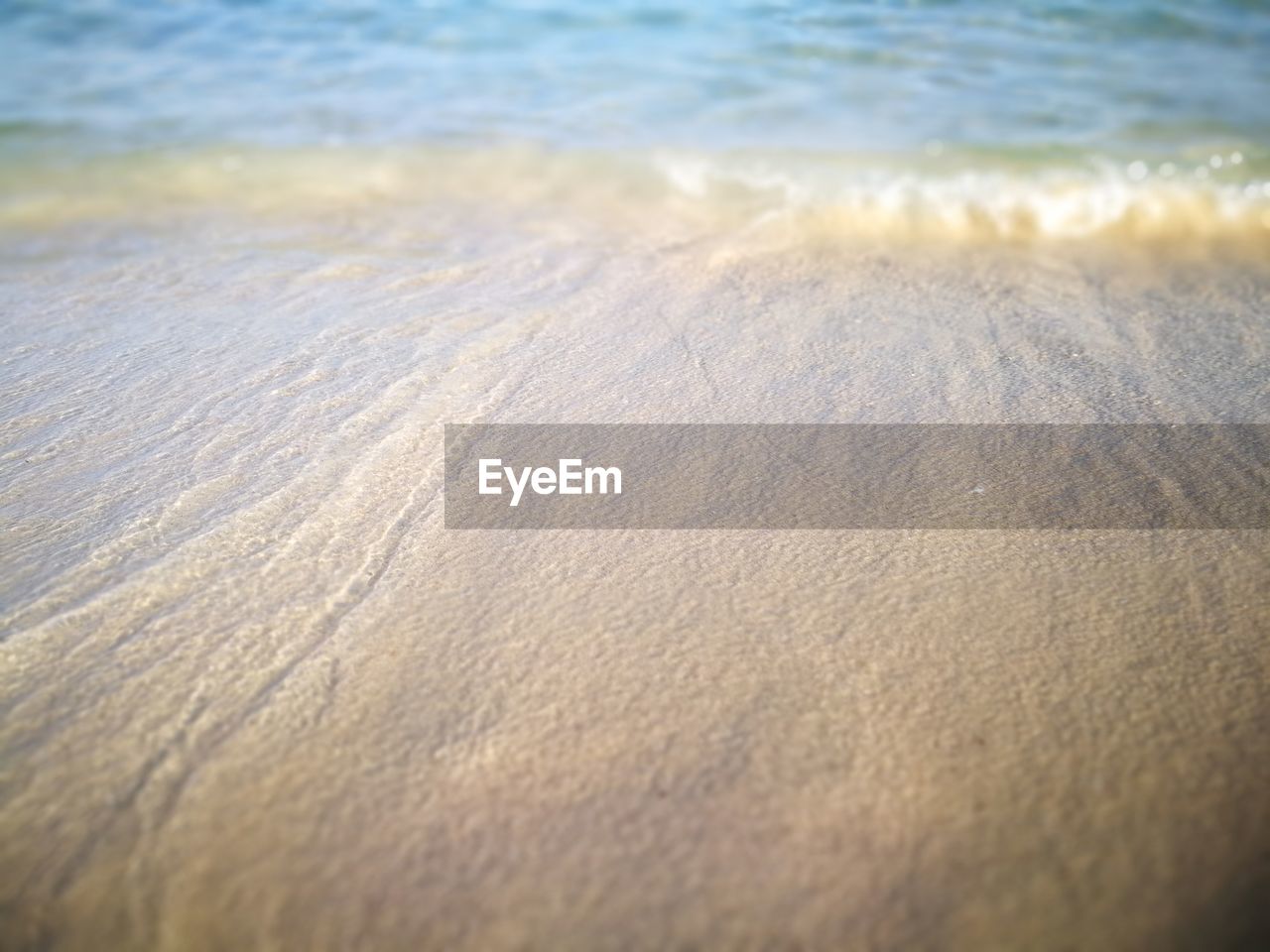 CLOSE-UP OF WAVES ON BEACH