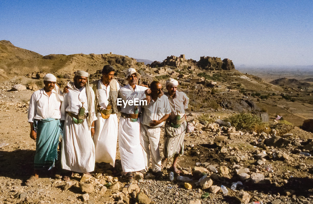 GROUP OF PEOPLE ON ROCK