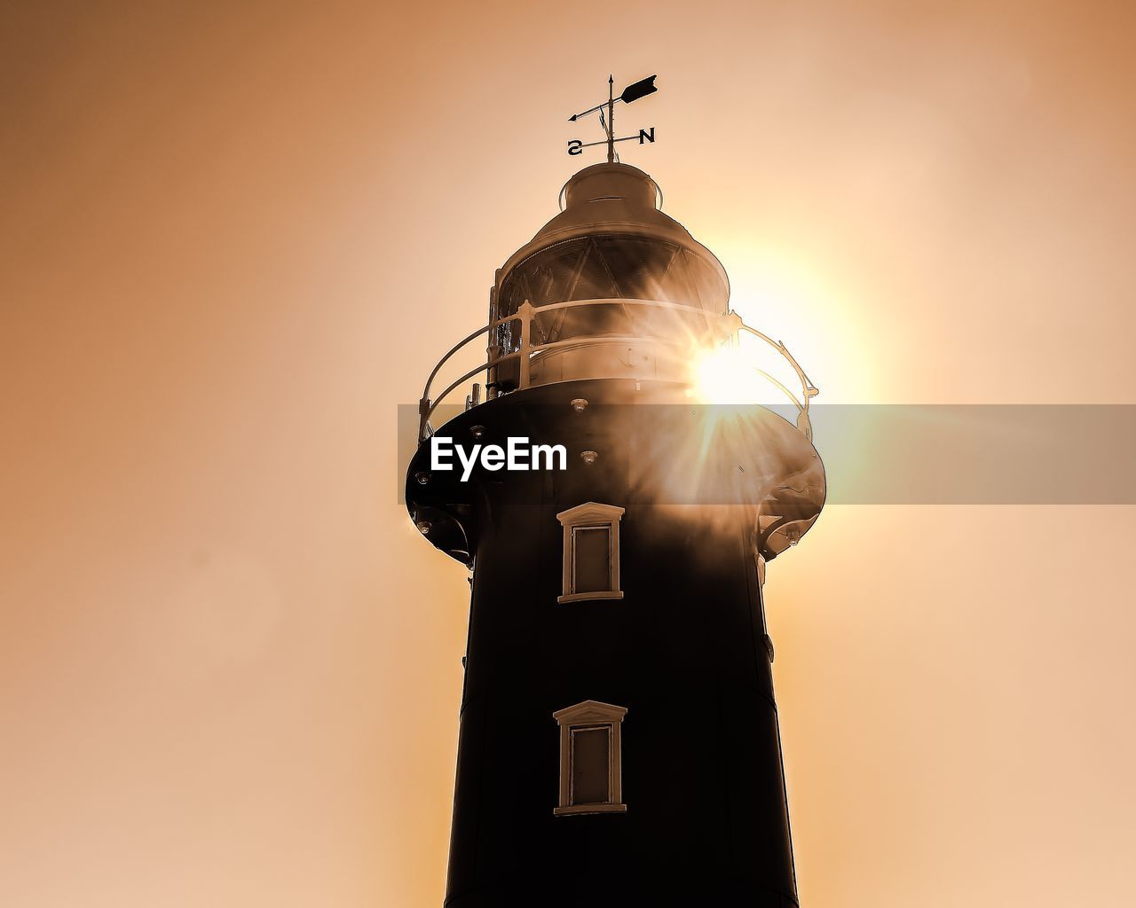 Low angle view of lighthouse against sky during sunset