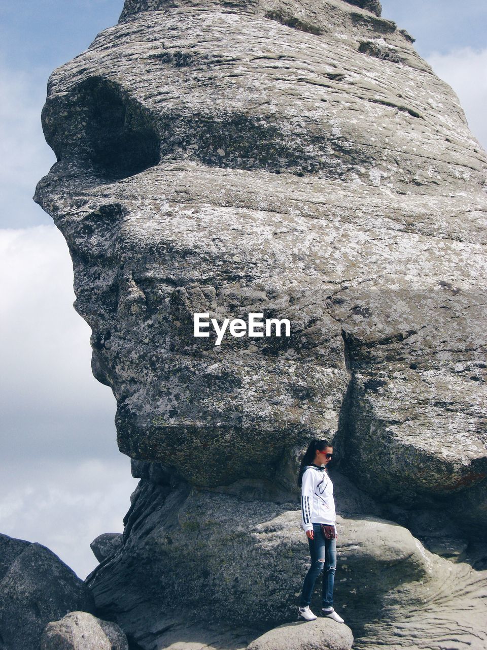 Full length of woman standing against sphinx at bucegi natural park