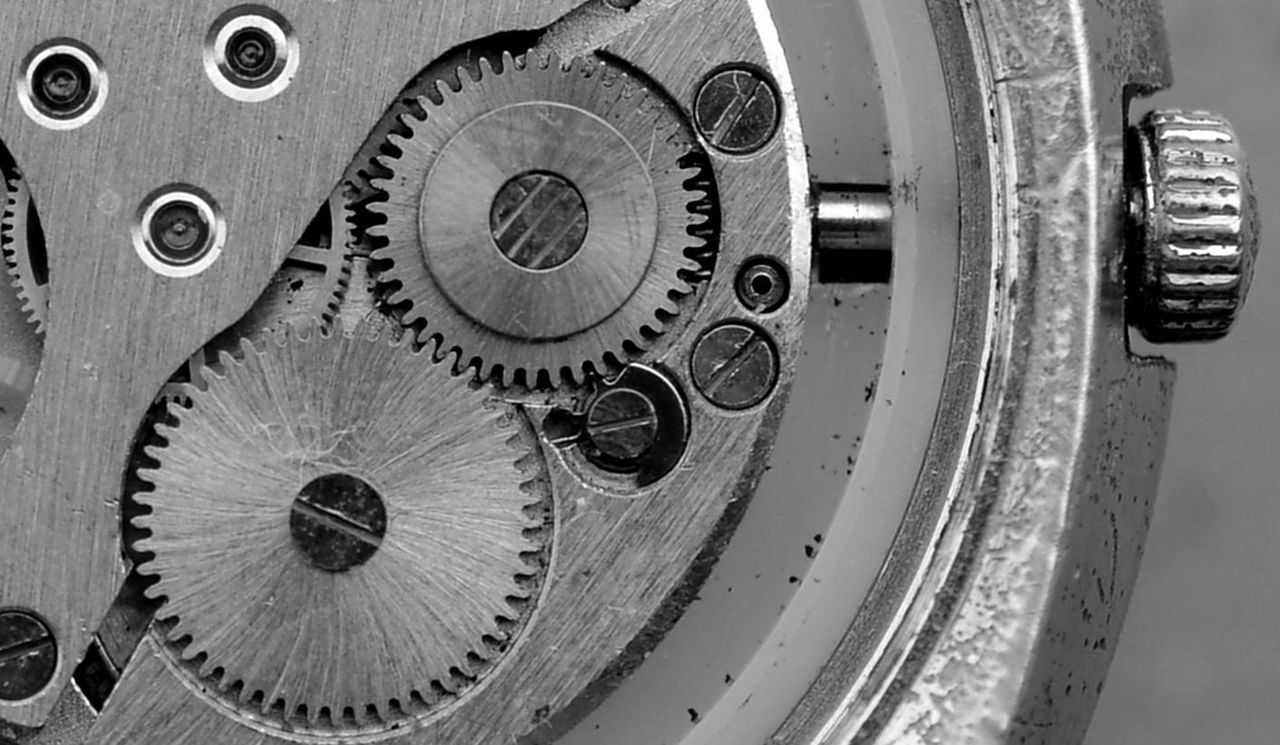 CLOSE-UP OF CLOCK ON METAL