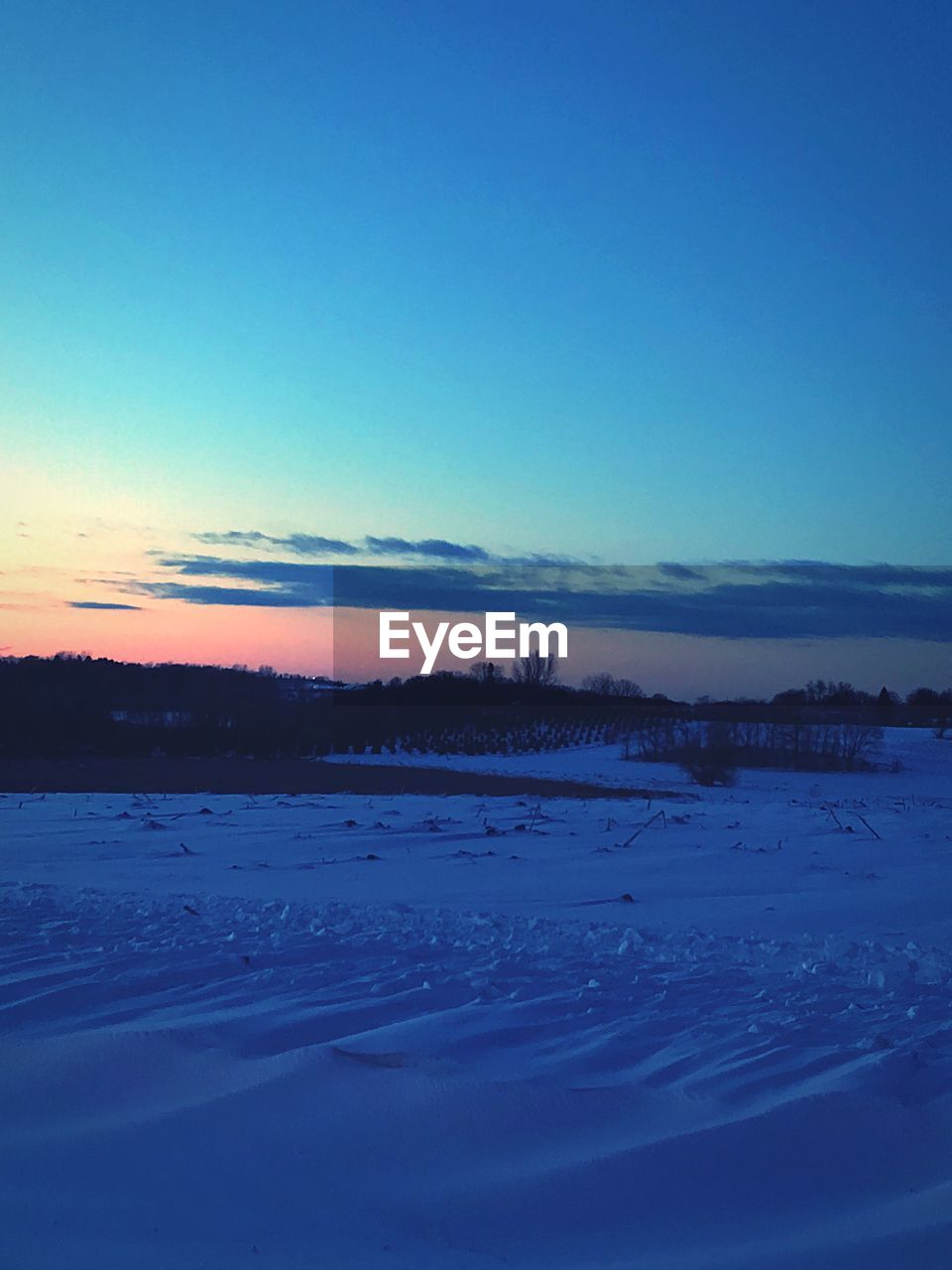 SCENIC VIEW OF FROZEN LANDSCAPE AGAINST CLEAR BLUE SKY DURING WINTER