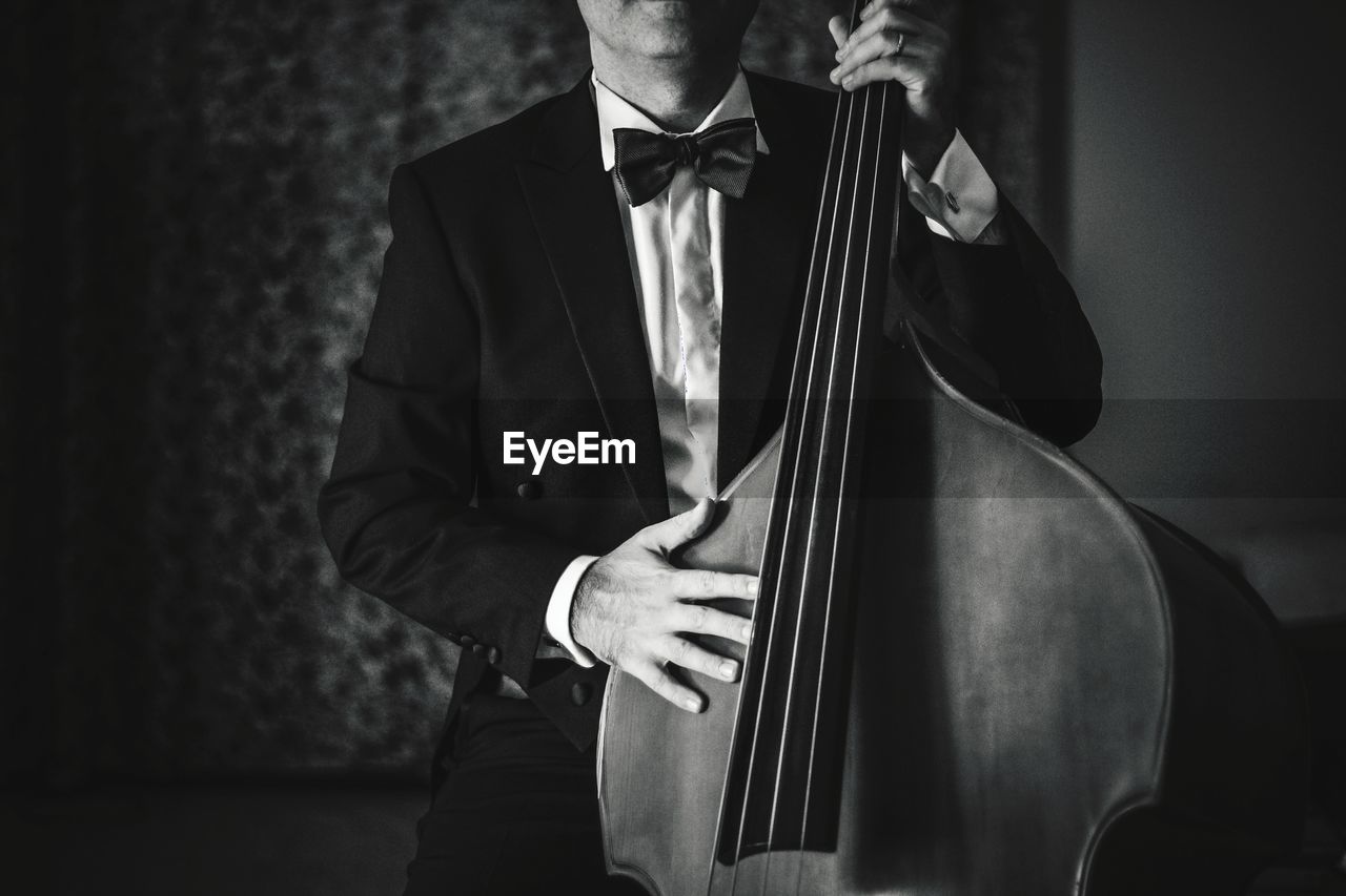 Full length of man playing double bass