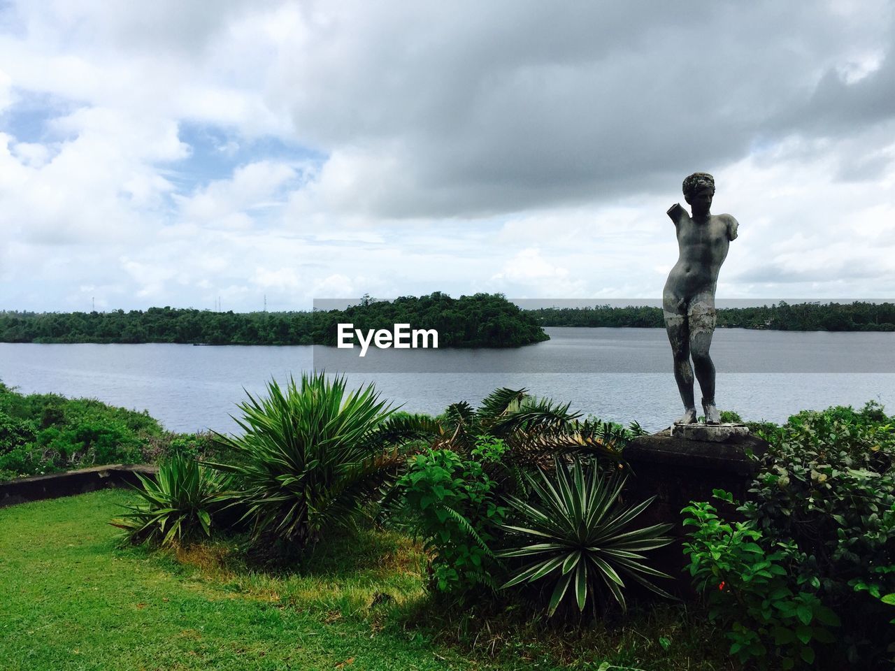 View of statue against calm lake