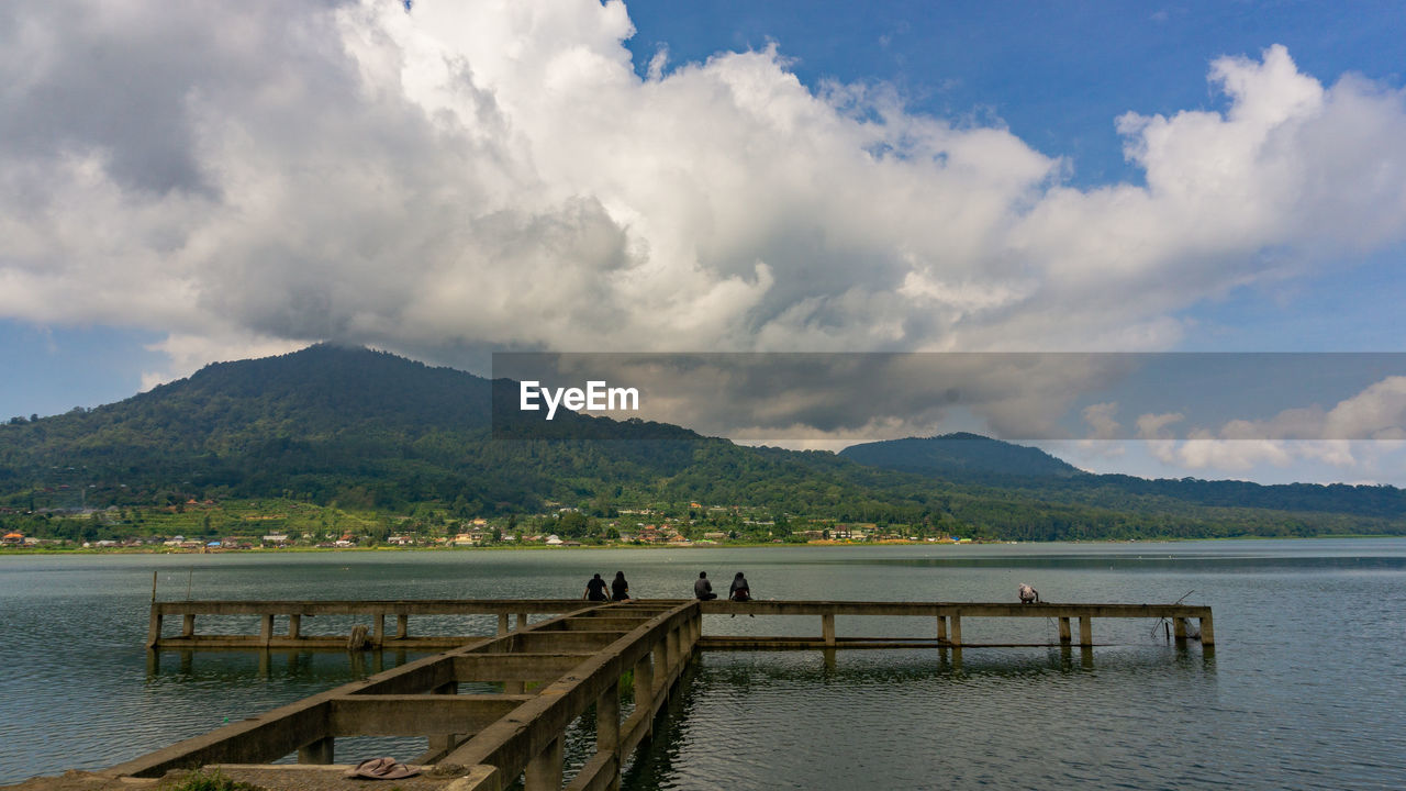 Pier over lake against mountains