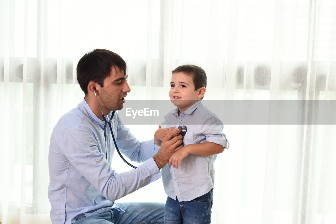 BOYS STANDING IN A ROOM