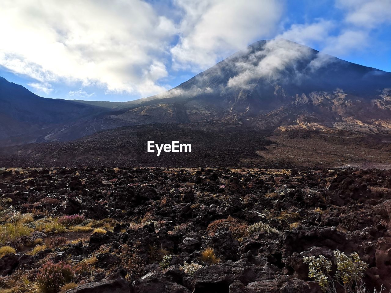 Aerial view of black rocks landscape against sky