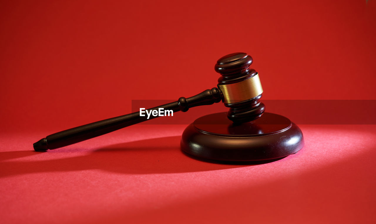 Gavel hammer on red background