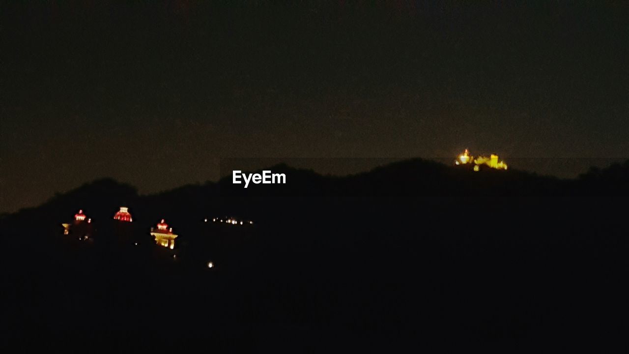 VIEW OF ILLUMINATED MOUNTAIN AT NIGHT