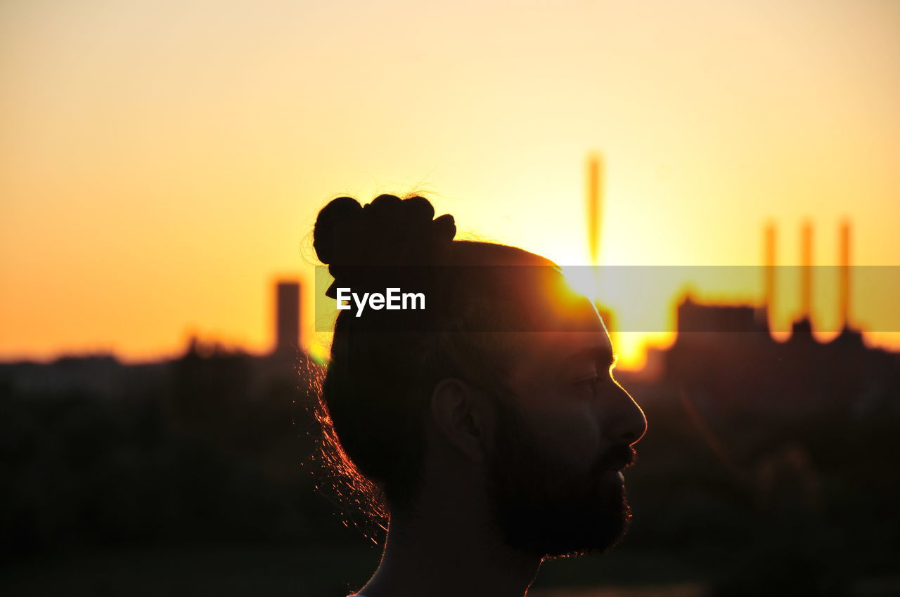 Close-up of silhouette man against clear sky at sunset