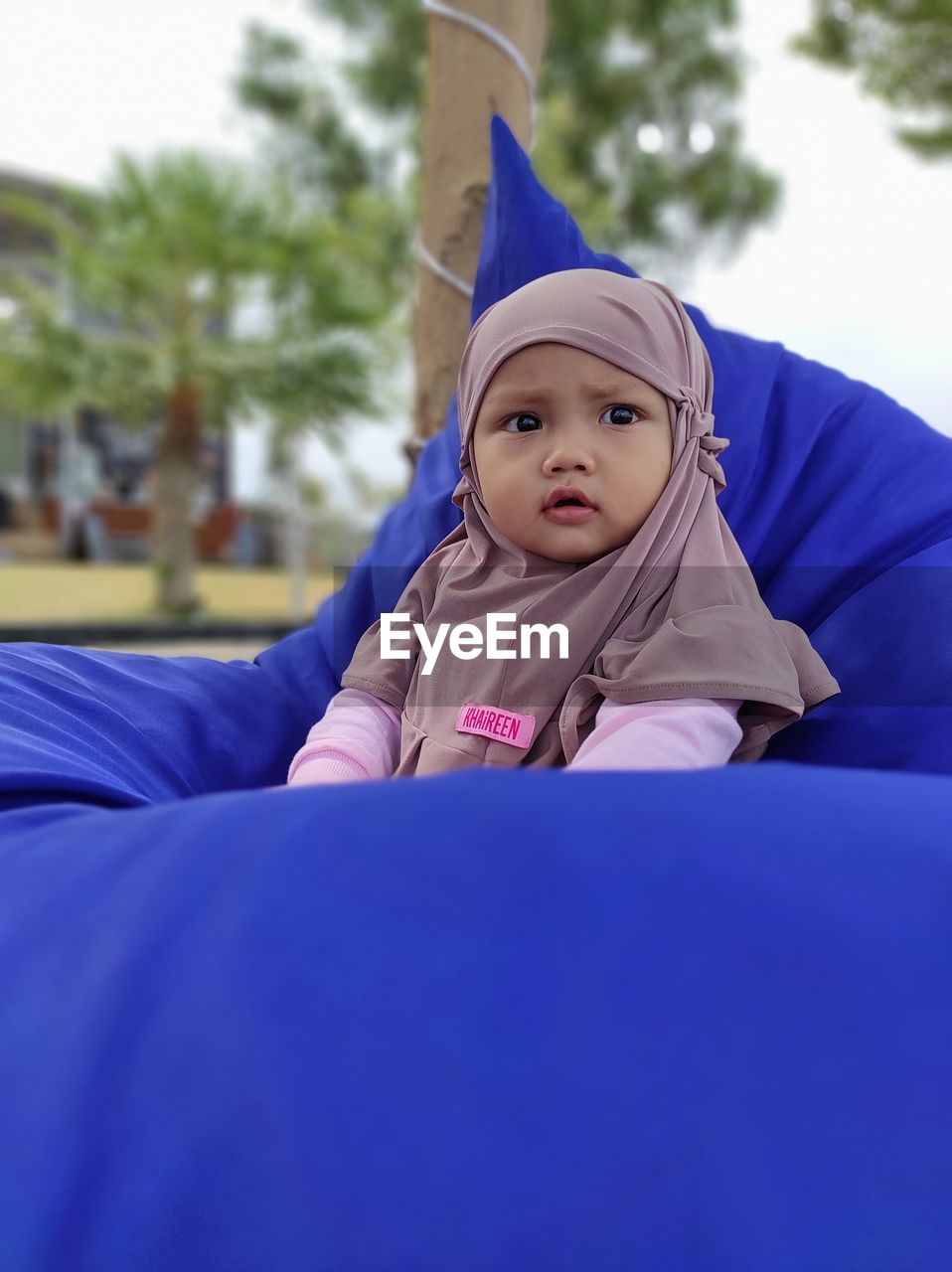 Portrait of cute girl against blue sky