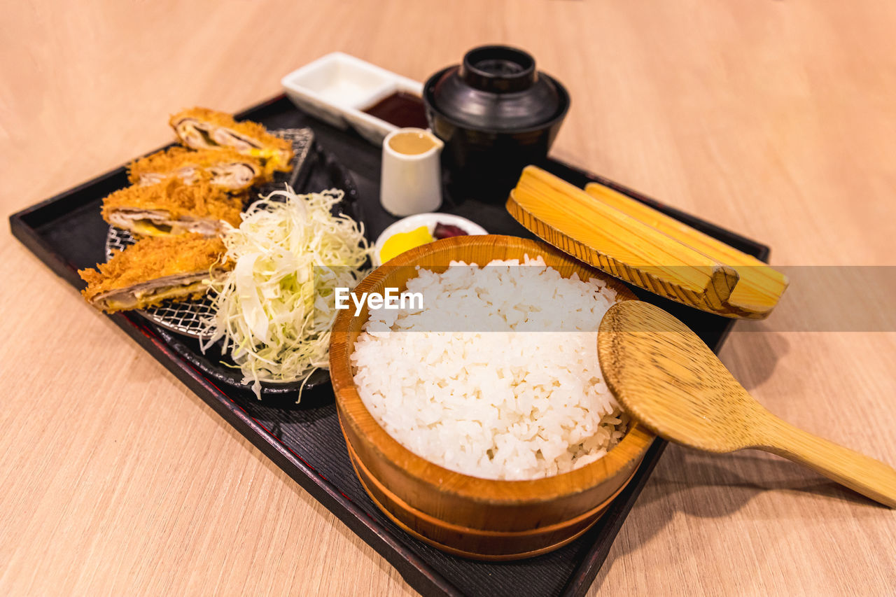 Tonkatsu set japanese food, deep fried breaded pork cutlet with rice, soup and sliced cabbage