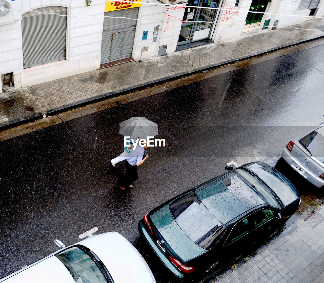 High angle view of woman standing on road 