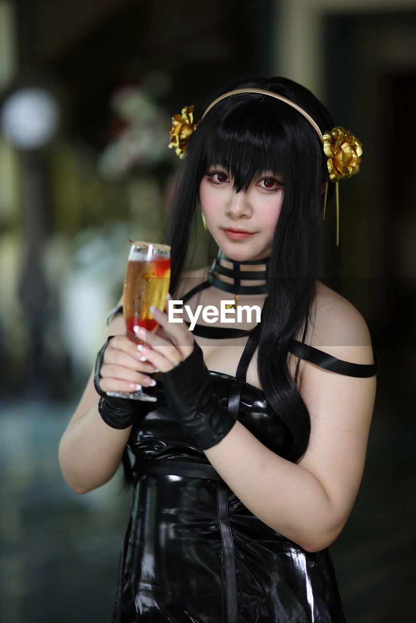portrait of young woman holding drink