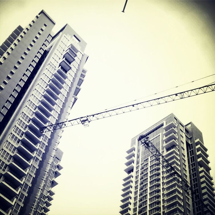 LOW ANGLE VIEW OF MODERN BUILDINGS AGAINST SKY