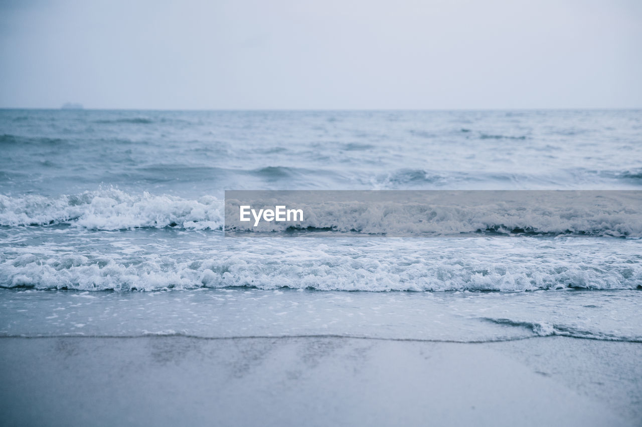 Scenic view of sea waves against clear sky