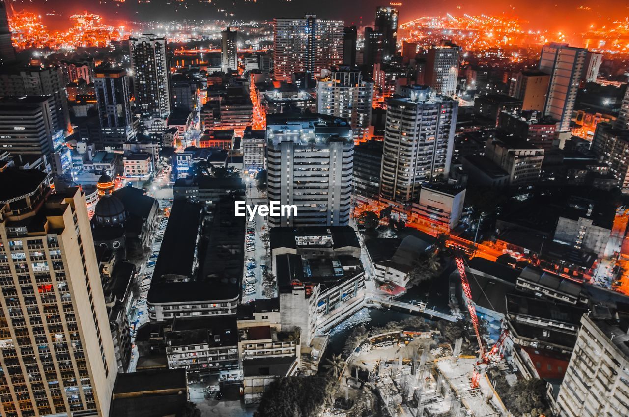 High angle view of illuminated buildings in city at night