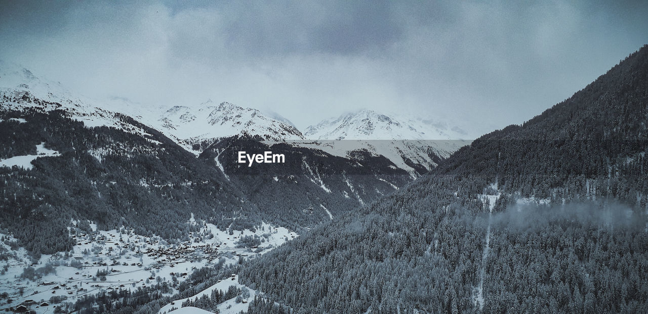 Scenic view of snowcapped mountains against sky