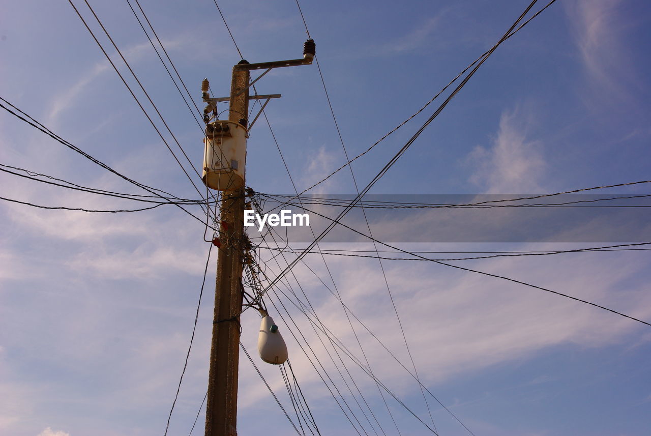 LOW ANGLE VIEW OF ELECTRICITY POLE AGAINST SKY