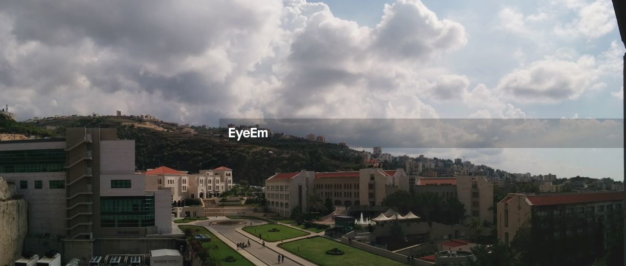 RESIDENTIAL BUILDINGS AGAINST CLOUDY SKY