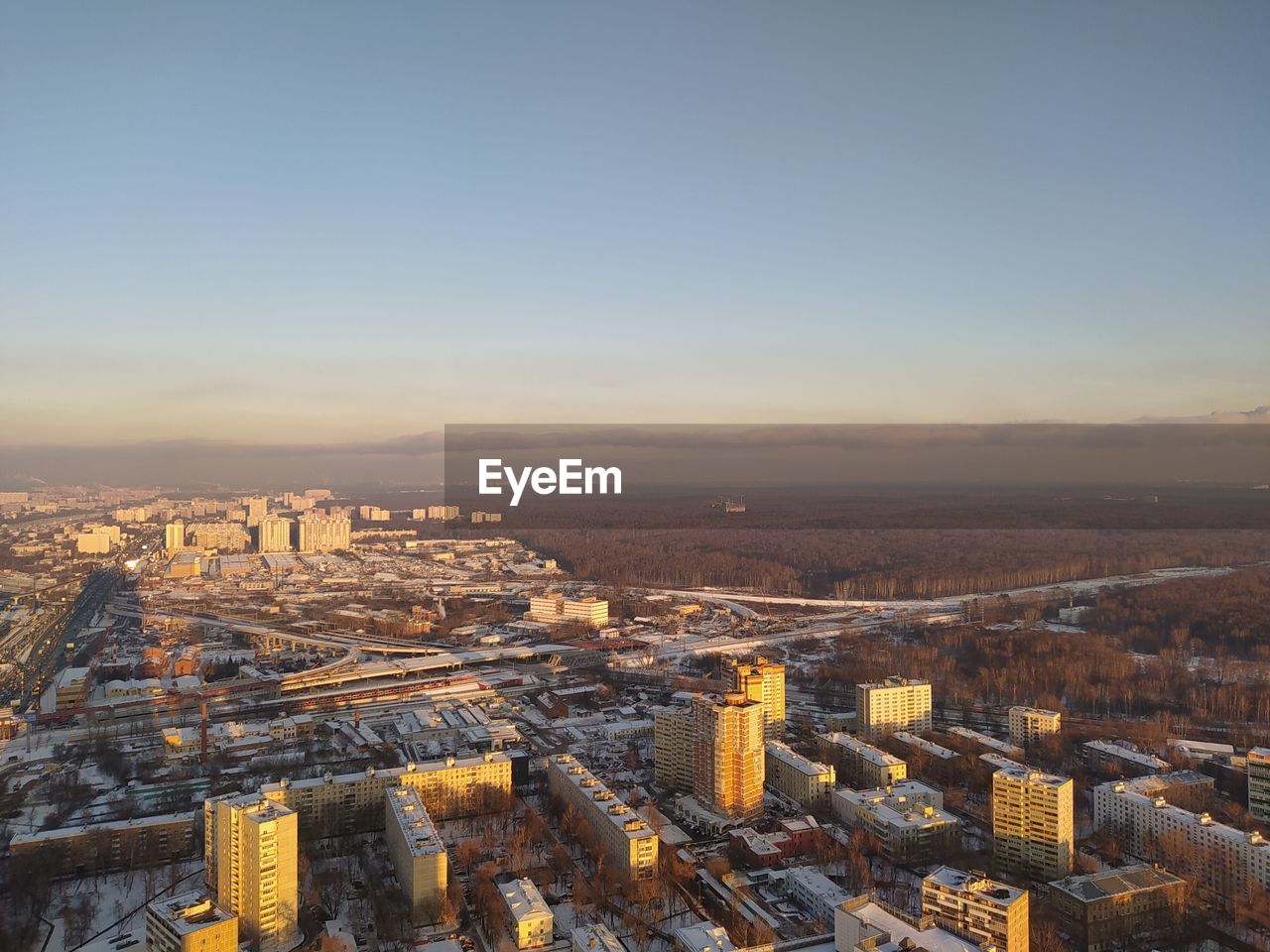 High angle view of buildings in city during sunset