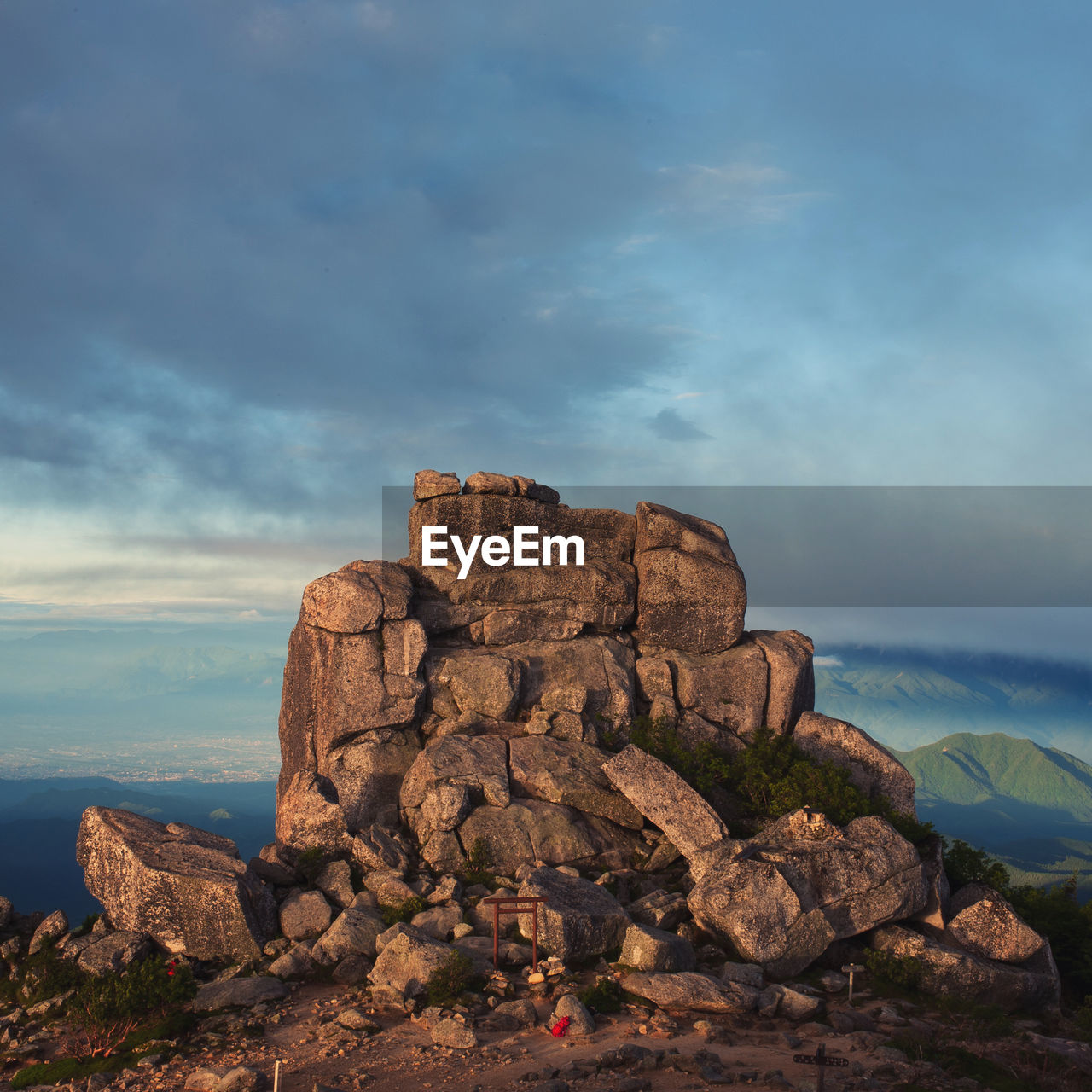 Scenic view of golden rock against sky