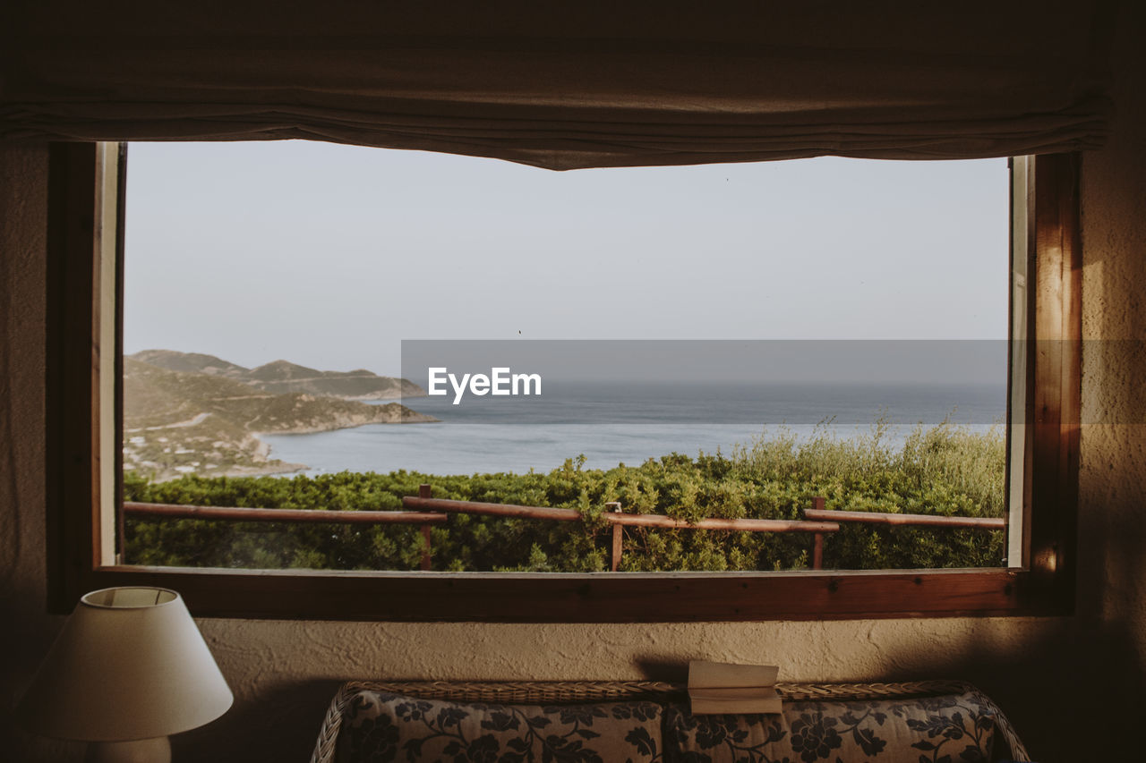 Scenic view of sea seen through window