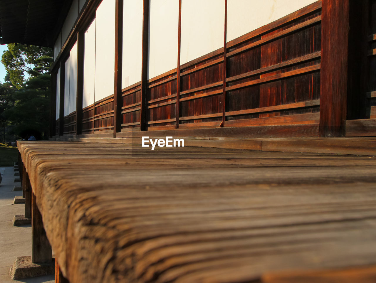 SURFACE LEVEL OF EMPTY BENCH AGAINST BUILDINGS
