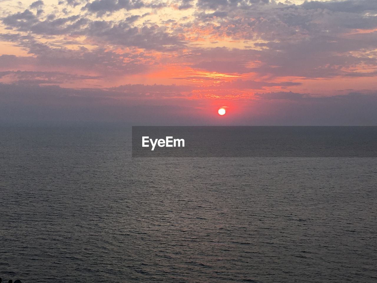 SCENIC VIEW OF SEA AGAINST ORANGE SKY