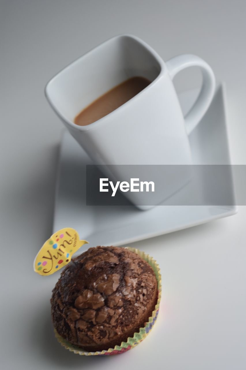 CLOSE-UP OF COFFEE CUP WITH FORK