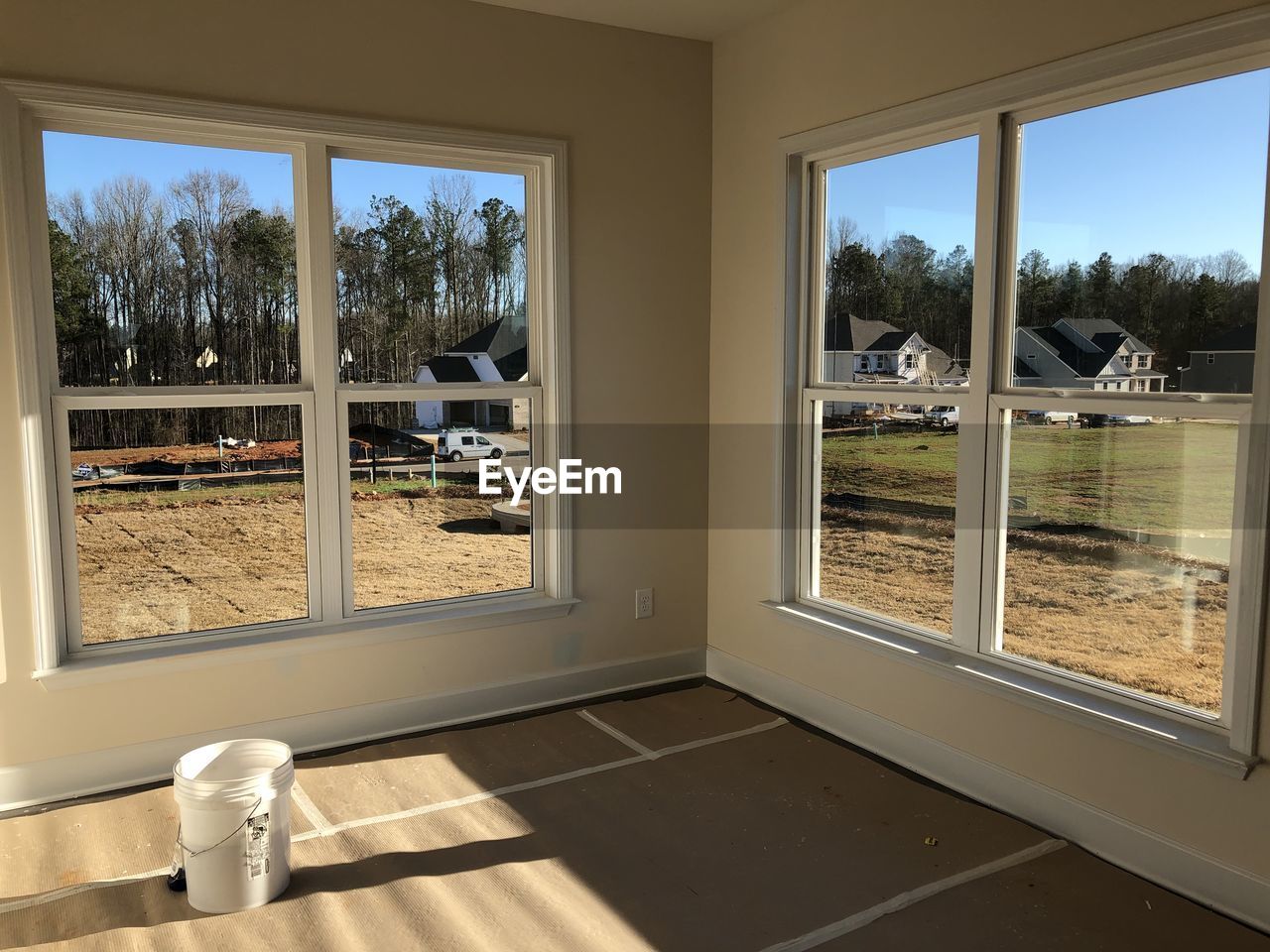 TREES AND BUILDING SEEN THROUGH WINDOW