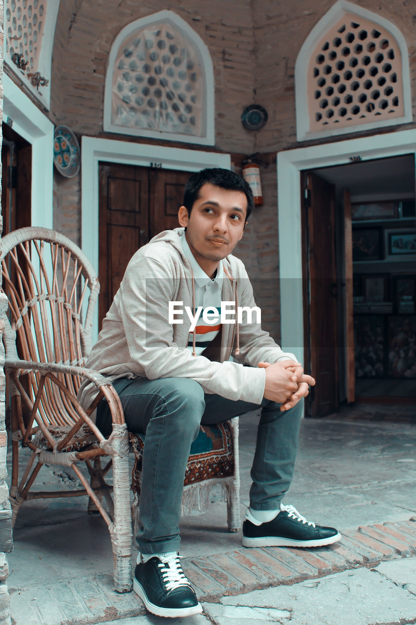 Portrait of young man sitting on seat