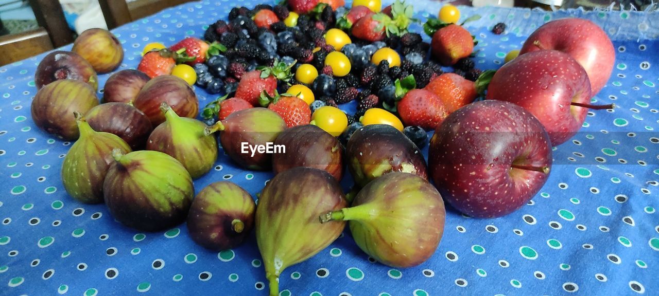 food and drink, food, healthy eating, fruit, freshness, wellbeing, produce, no people, still life, high angle view, plant, indoors, large group of objects, variation, blue, berry, abundance, close-up, multi colored, table